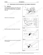 new-holland-dc150-b-crawler-dozer-service-manual-603-67-081-00-procedures-75.webp New Holland DC150.B torque converter removal procedure, showing ignition switch, lower guard, and transmission oil drain plugs.